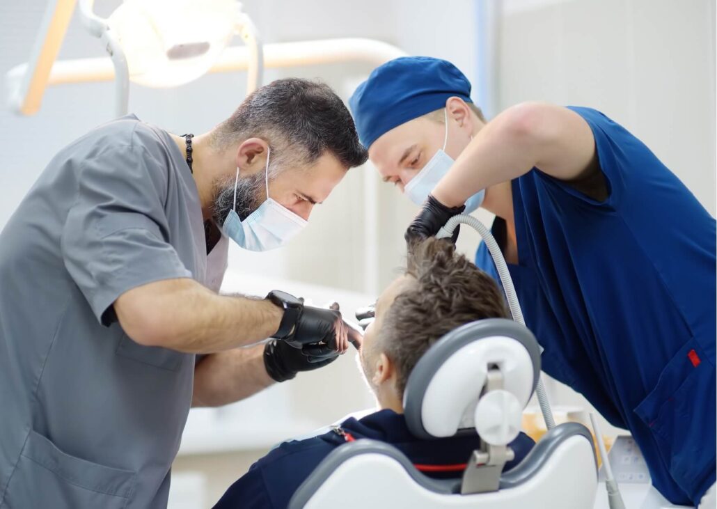 Dental team performing a dental implant procedure for a patient after determining they are a suitable implant candidate.
