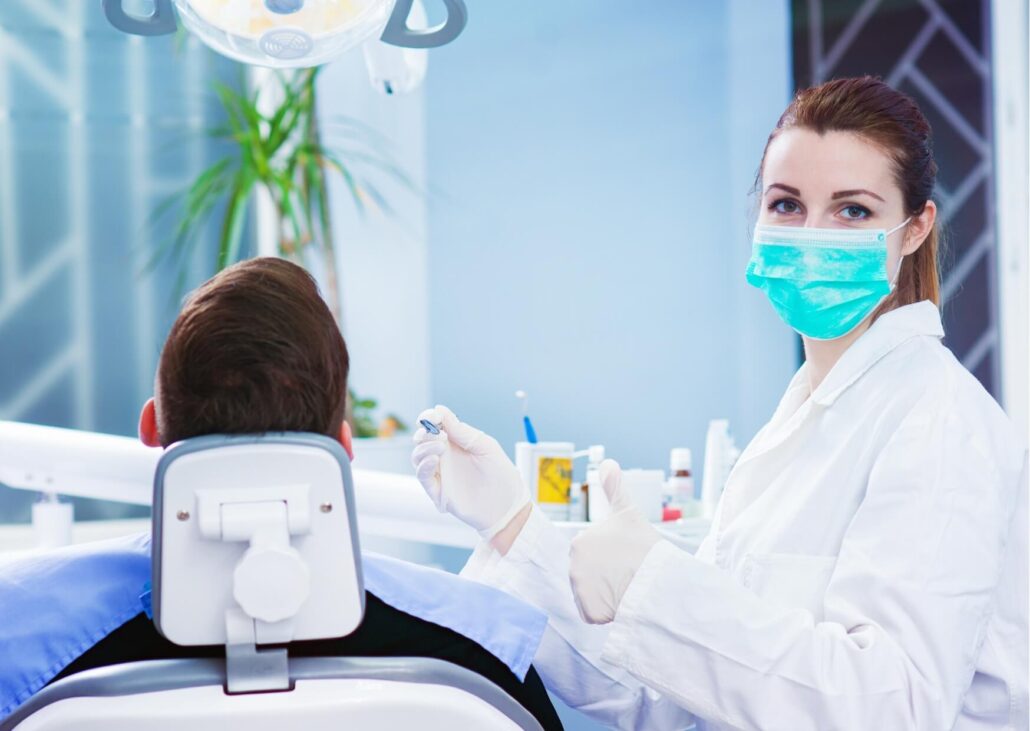Dentist preparing to perform tooth bonding on a patient to restore the shape, color, and appearance of a damaged tooth.