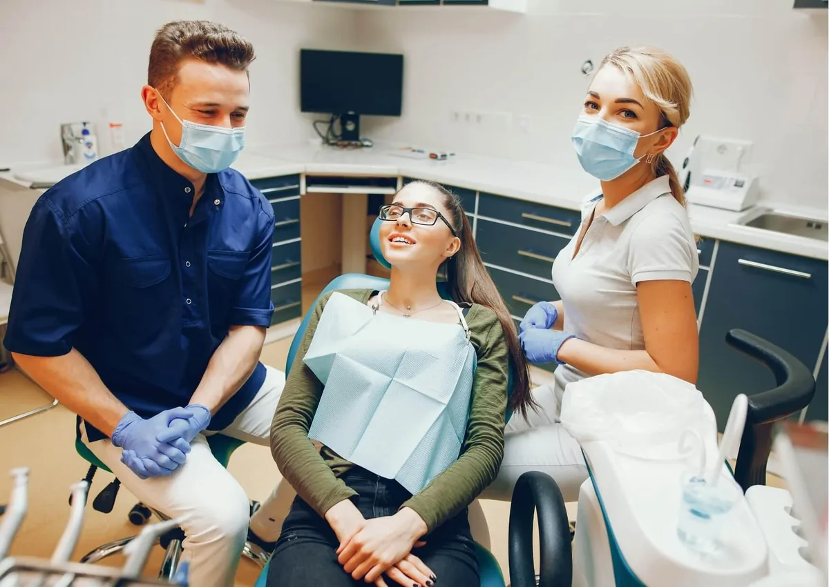 Patient meeting with a dental team to discuss cosmetic dentistry options and treatment costs.